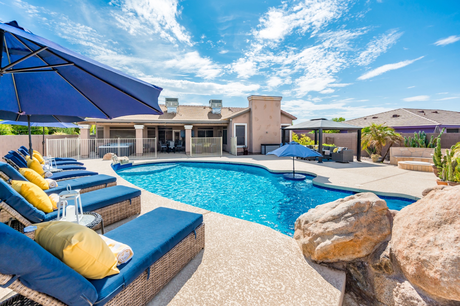 Pool patio with loungers, umbrellas, gazebo and hot tub area