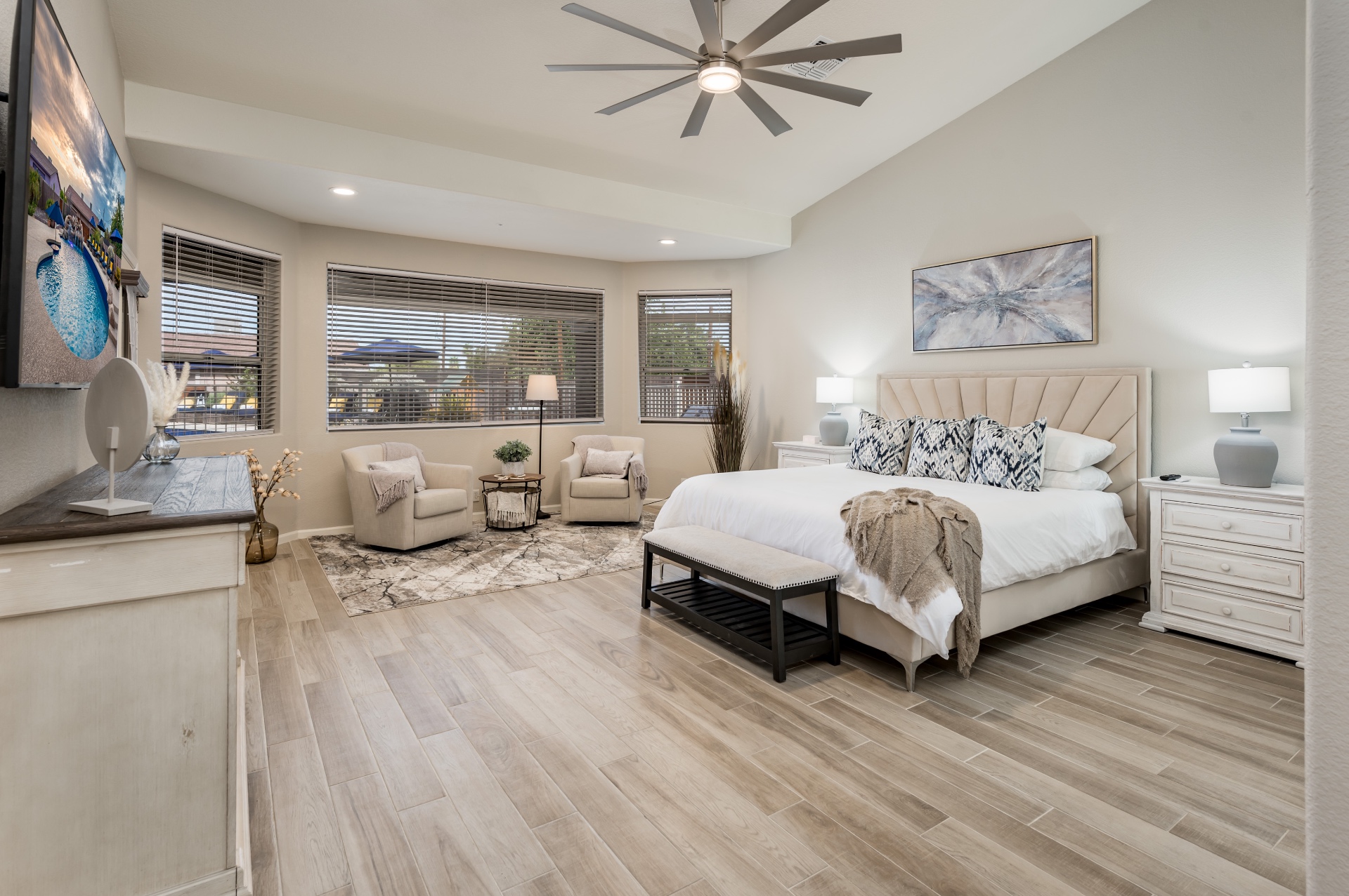 Primary bedroom with king bed, vaulted ceiling and sitting area