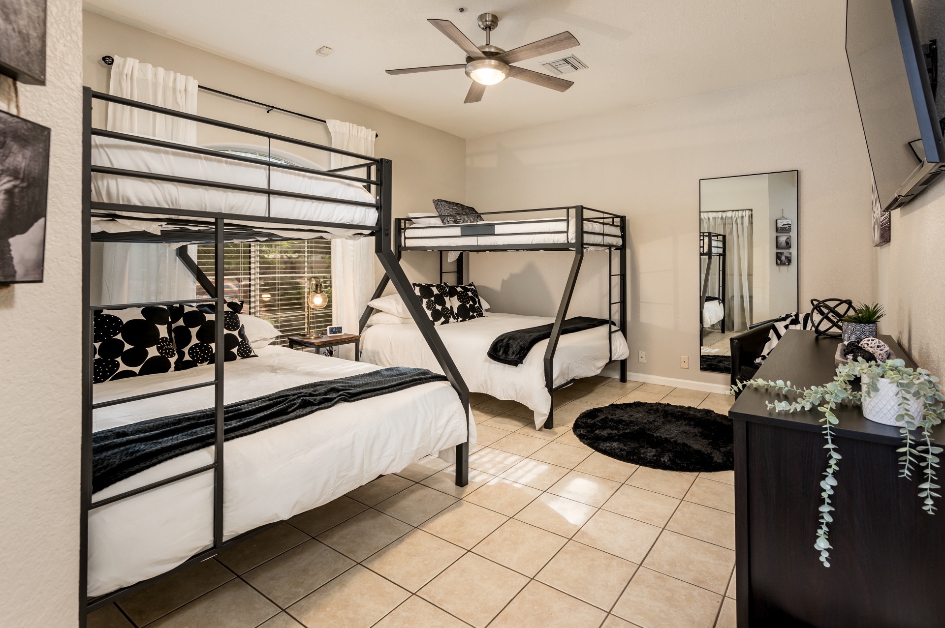 Bunk room with two twin-over-full bunks and black-and-white decor