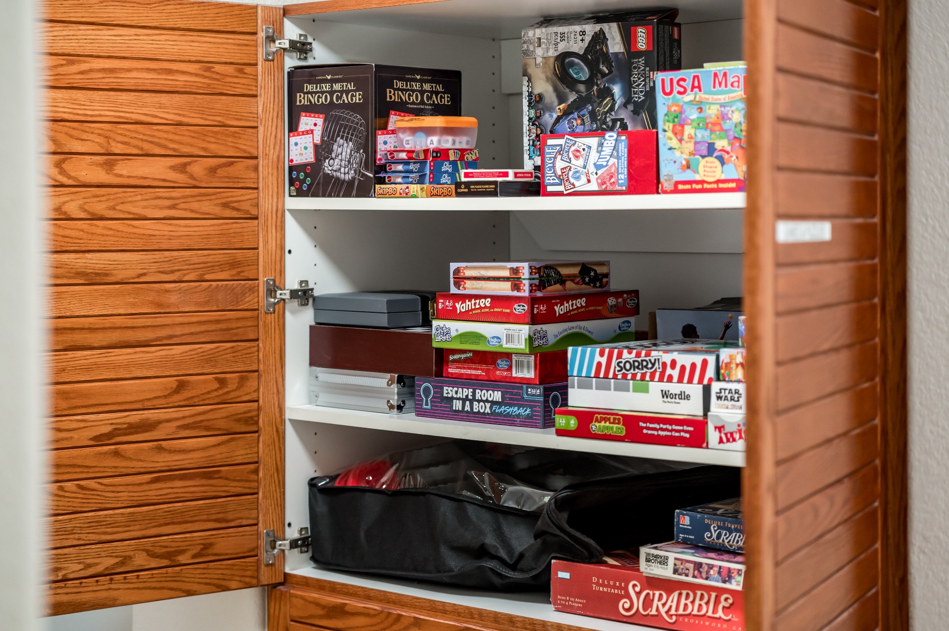 Cabinet stocked with board games, cards and puzzles