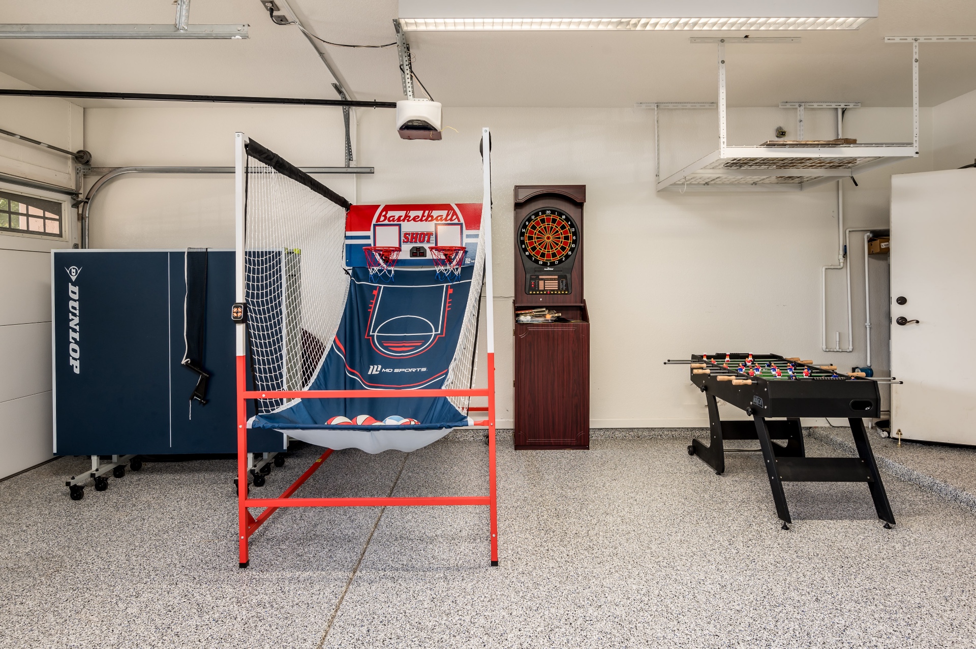 Garage game area with ping pong, basketball arcade, darts and foosball