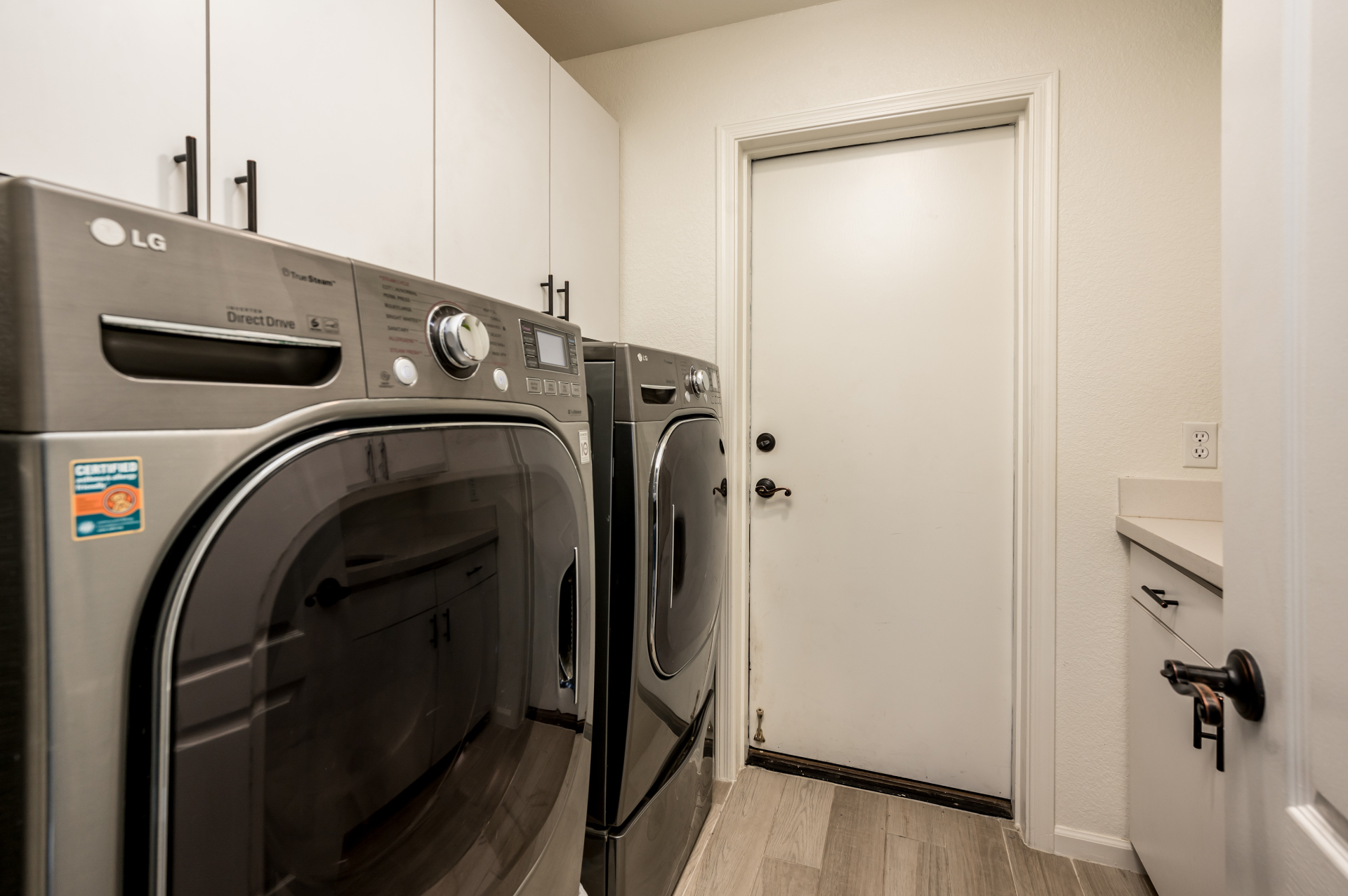 Laundry room with full-size LG washer and dryer