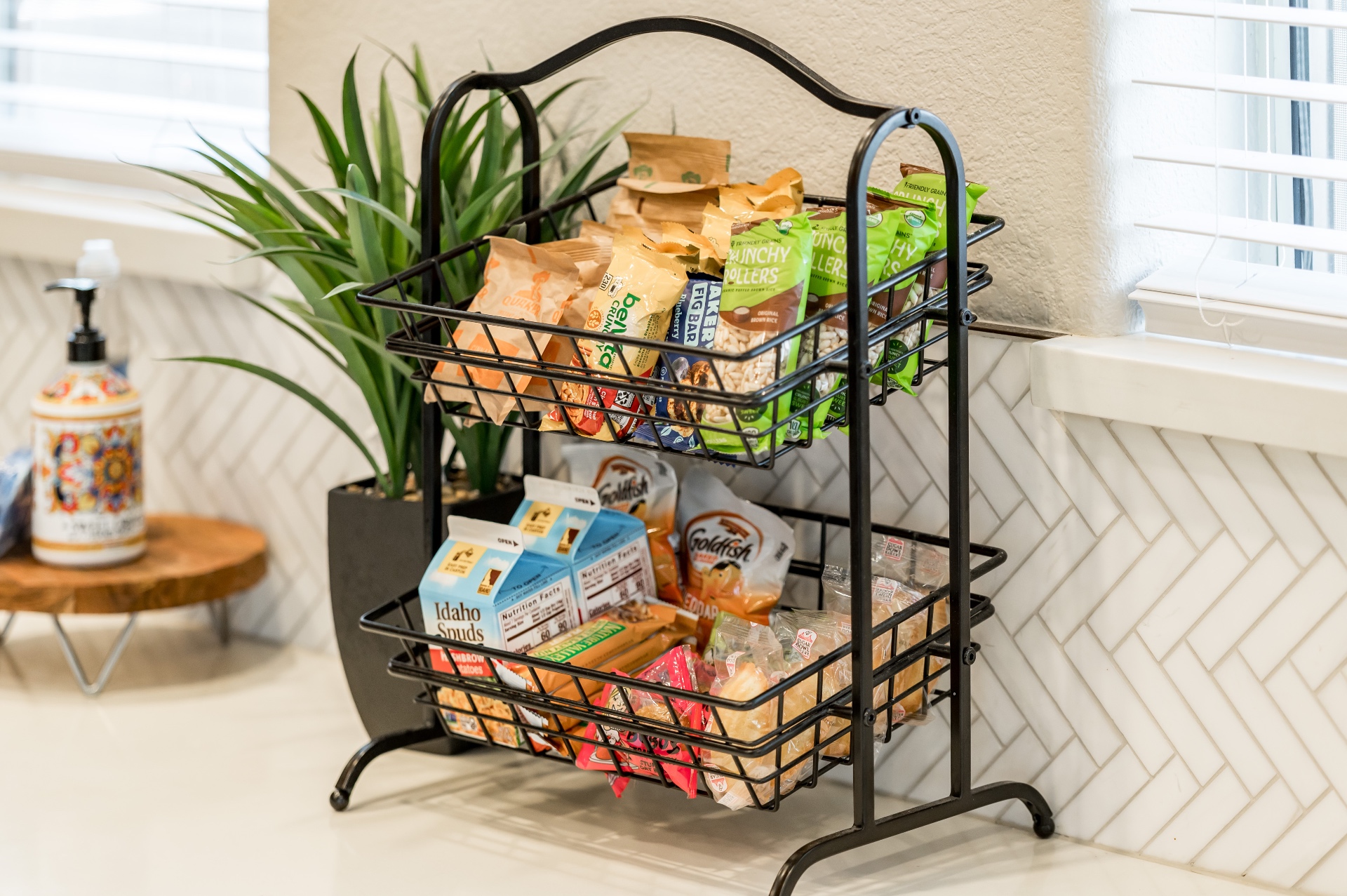 Two-tier basket stocked with assorted snacks for guests