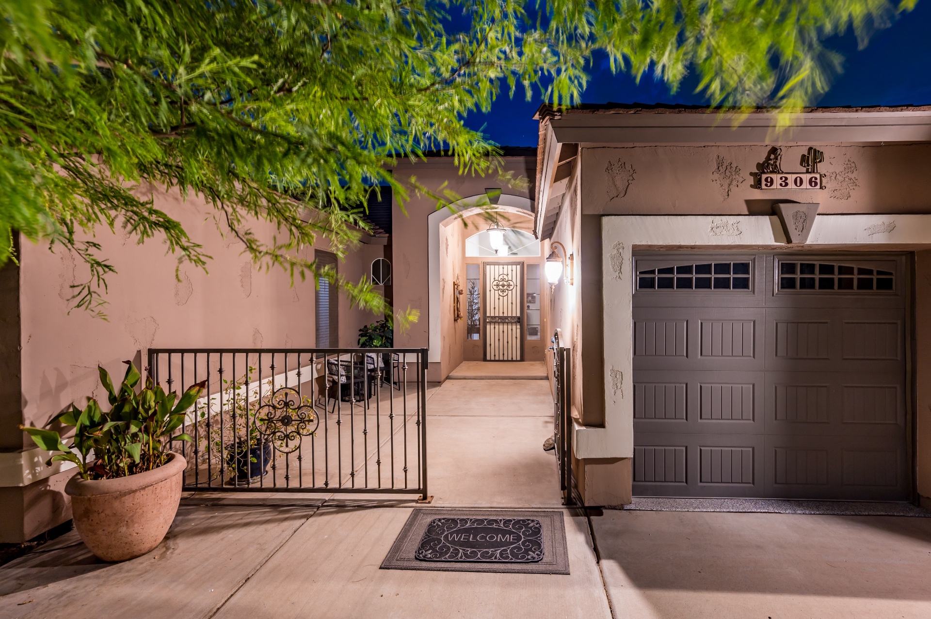 Welcoming gated entry walkway lit at night