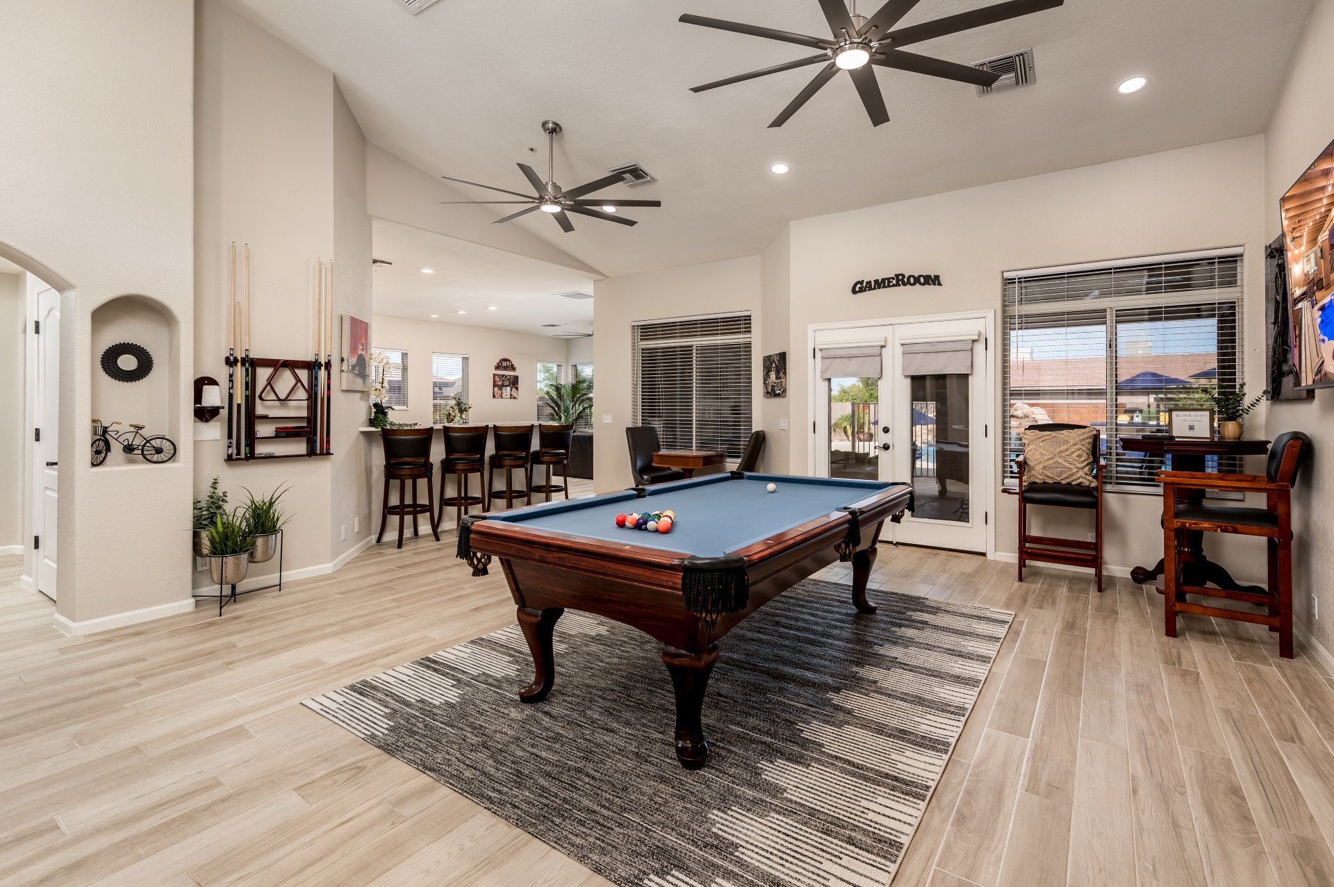 Game room with pool table, bar seating and vaulted ceilings