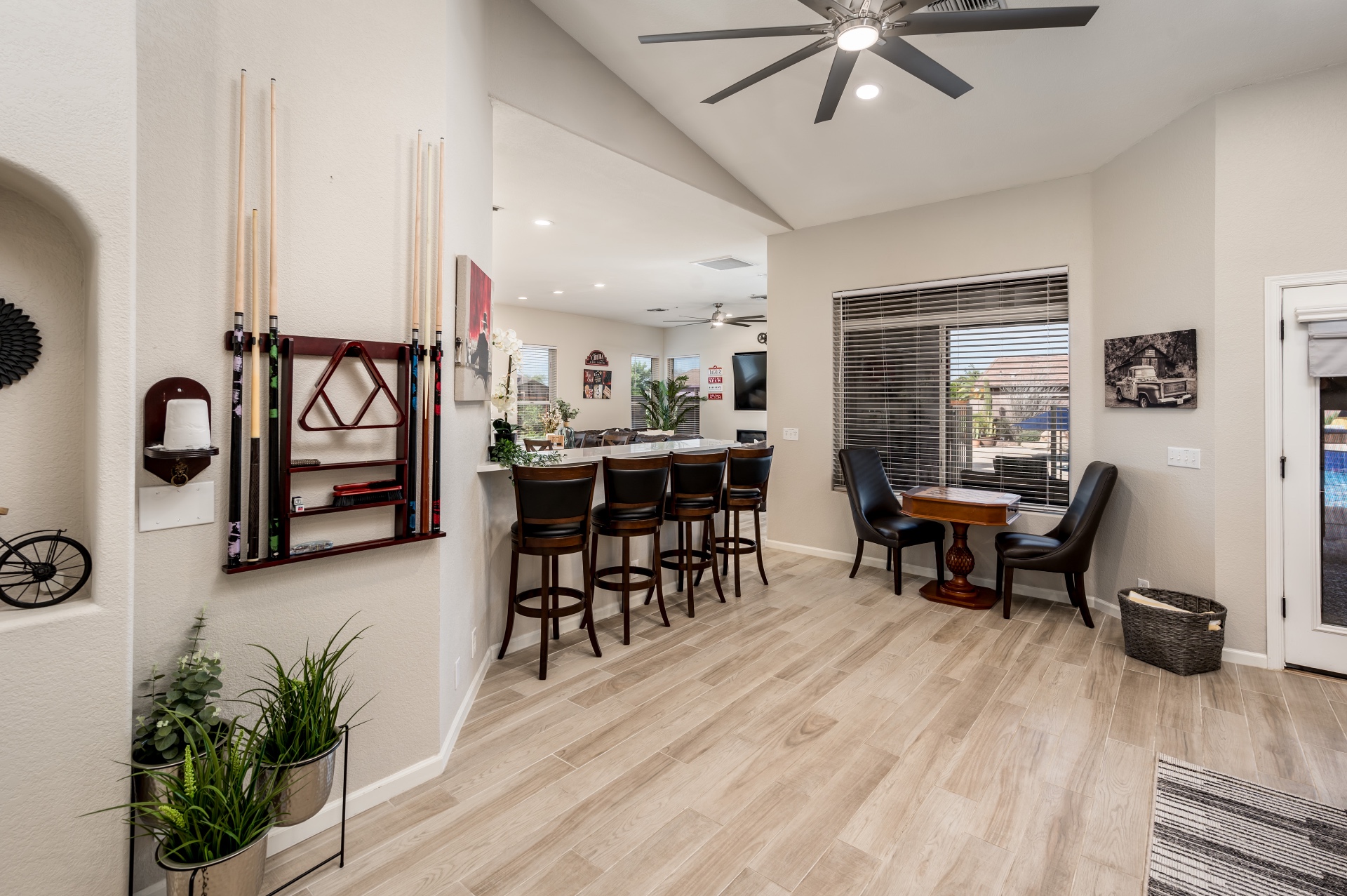 Bar seating area with cue rack and game table by the window