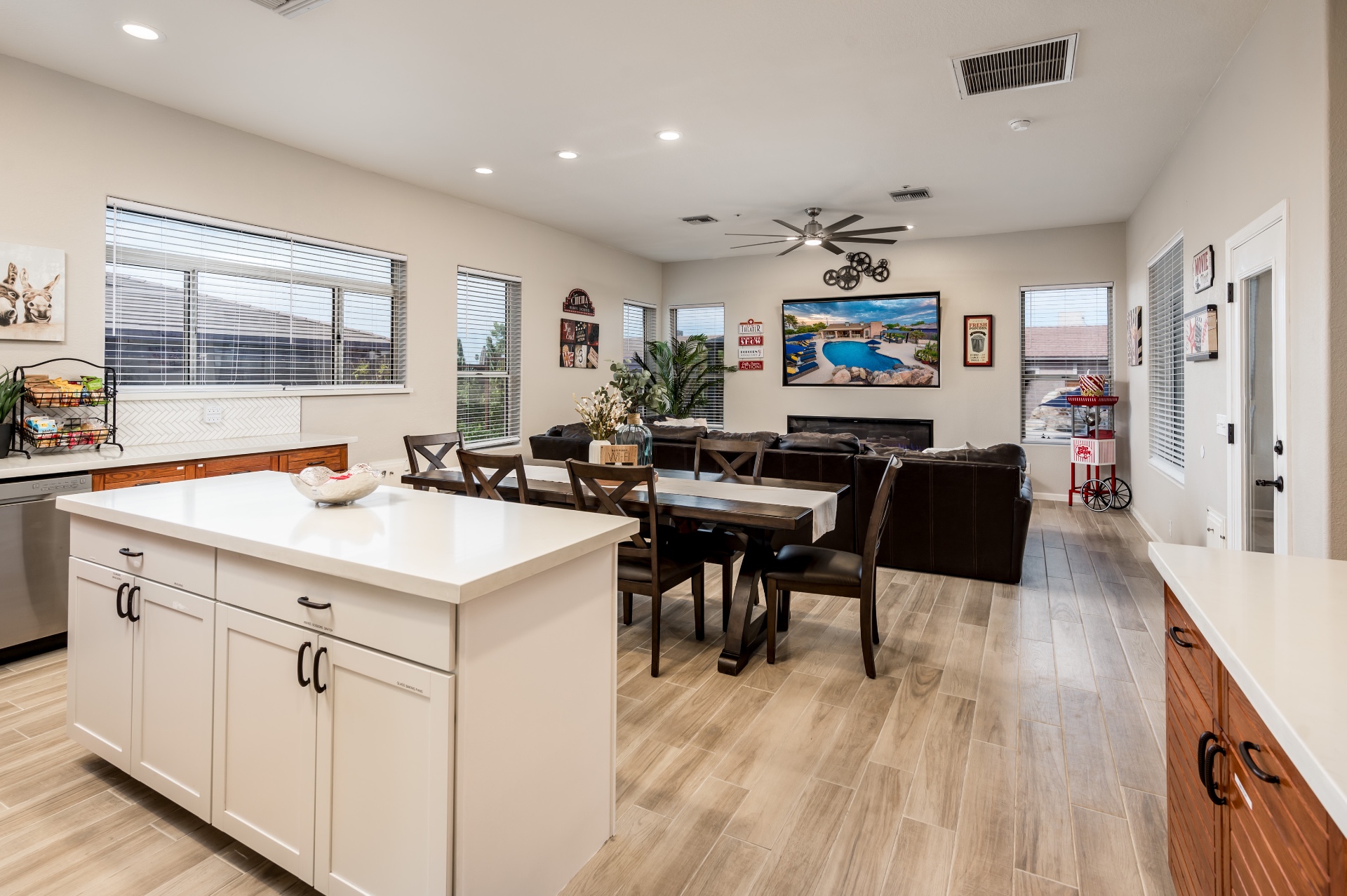 Open kitchen, dining and living area with fireplace and mounted TV