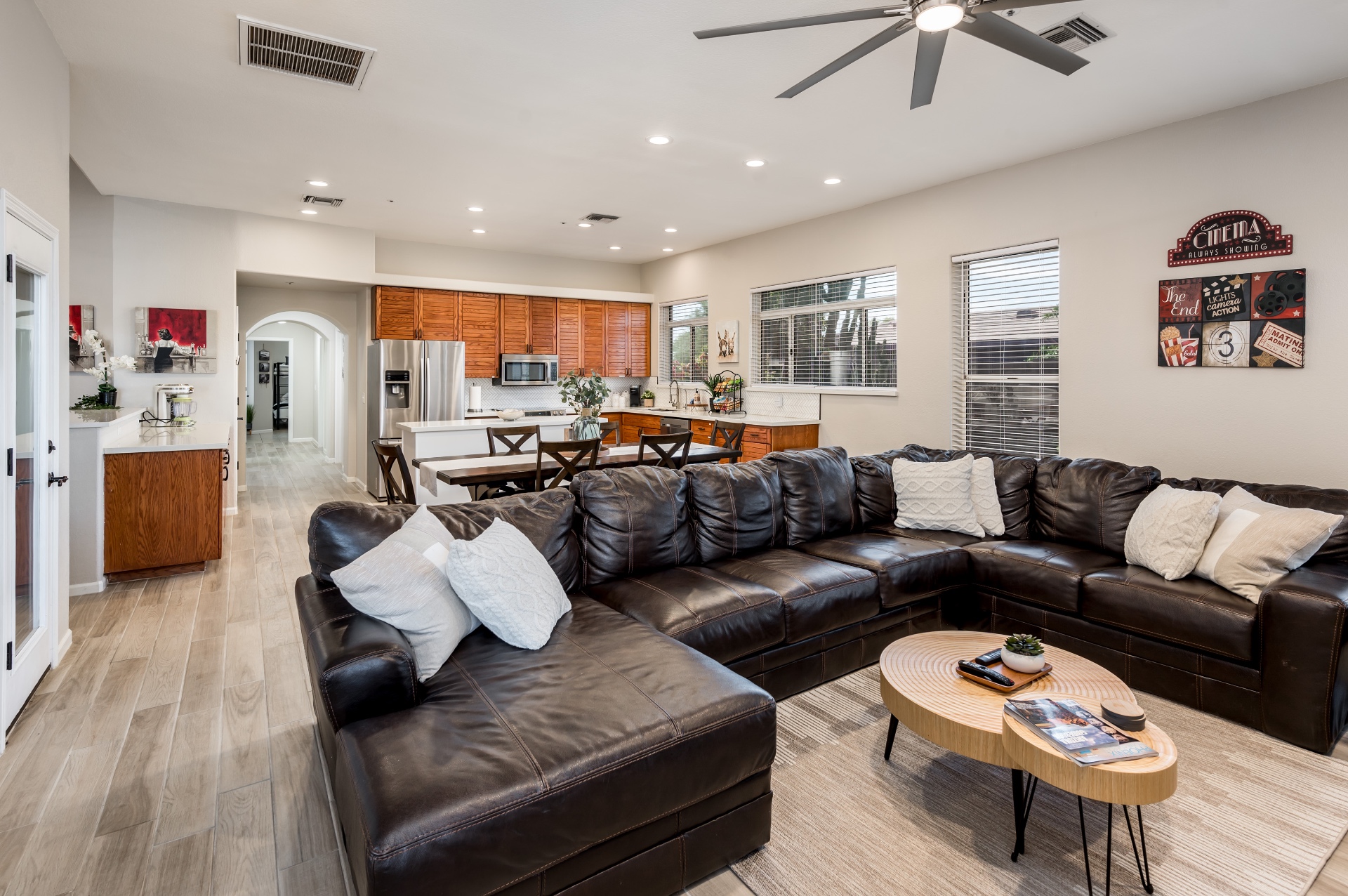 Wide view of living room sectional opening into the kitchen